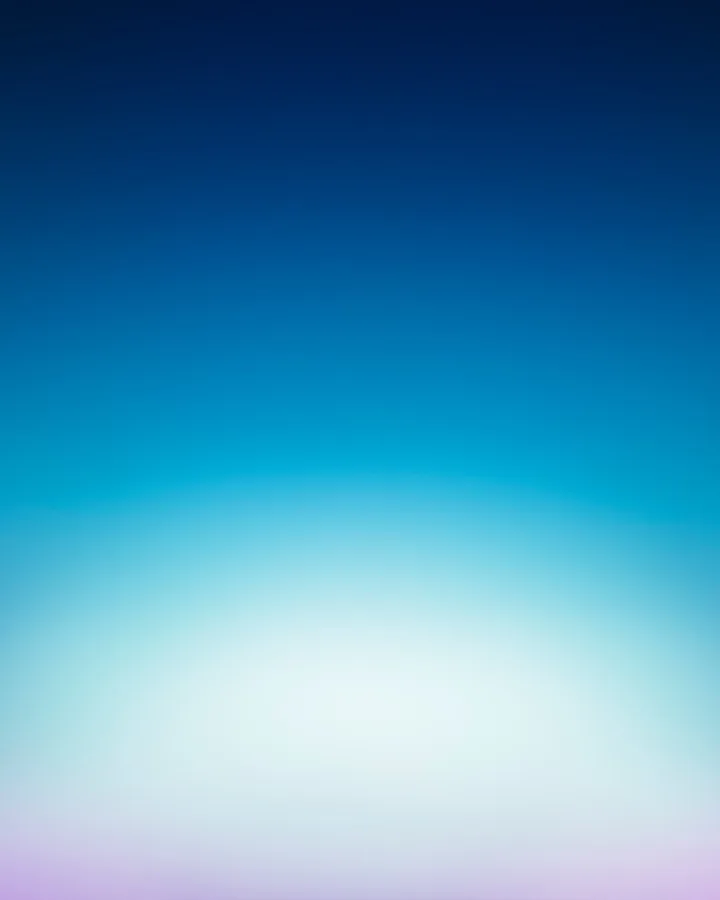 A soft gradient from near-black navy at the top through teal to a pale white glow, with a faint lilac edge at the bottom.