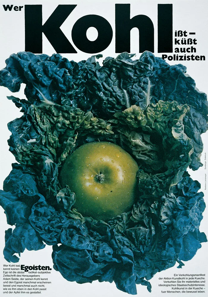 Poster reading Wer Kohl isst, küsst auch Polizisten: a huge black Kohl above a photograph of a green apple nested in blue-green cabbage leaves, with small text columns at the bottom.