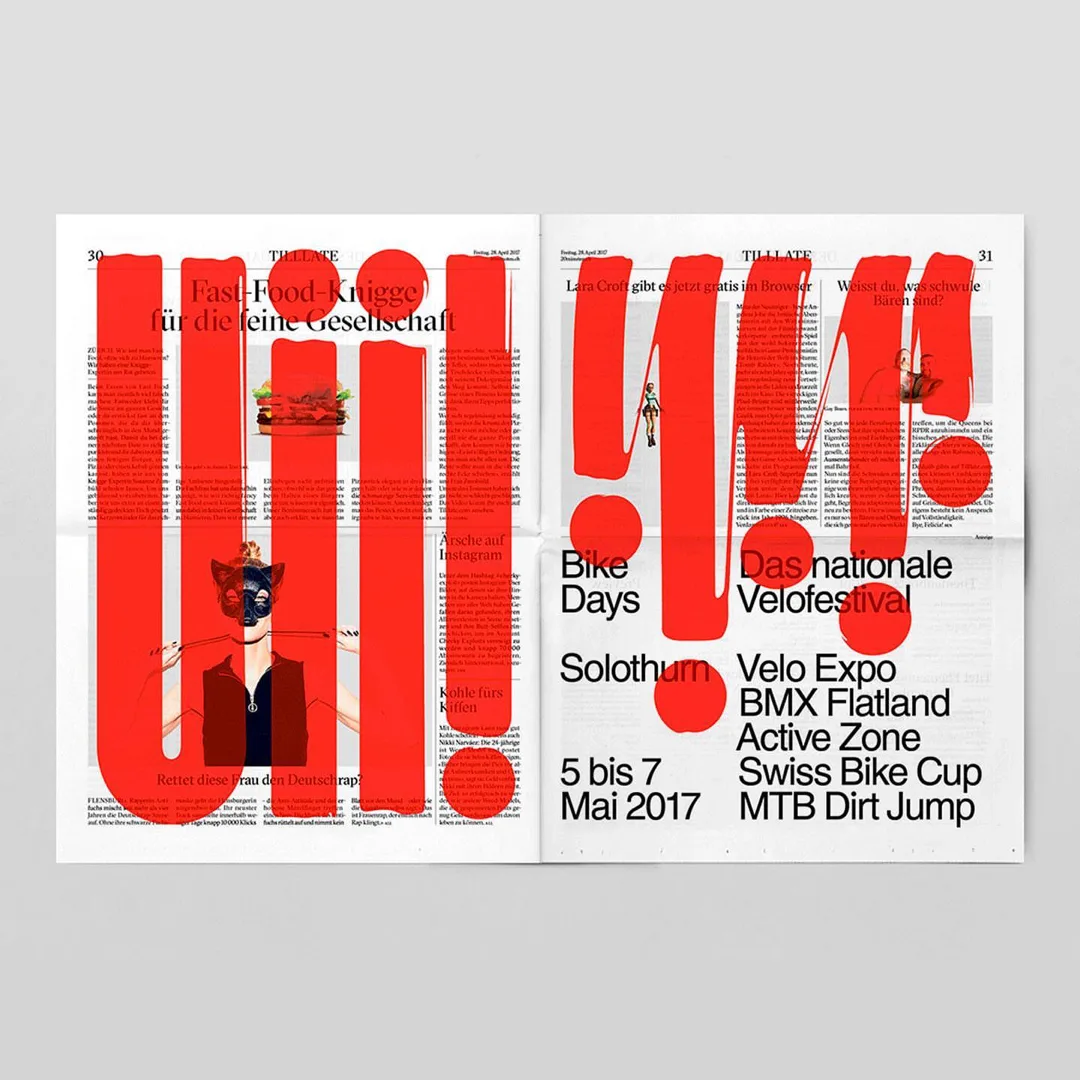 A newspaper spread with huge red brush-painted letters laid over text and photos.